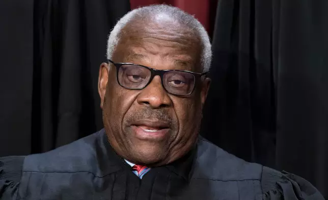 FILE - Supreme Court Associate Justice Clarence Thomas joins other members of the Supreme Court as they pose for a new group portrait, at the Supreme Court building in Washington, Oct. 7, 2022. Thomas was nominated by President George H. W. Bush to succeed Justice Thurgood Marshall and has served since 1991. (AP Photo/J. Scott Applewhite, File)