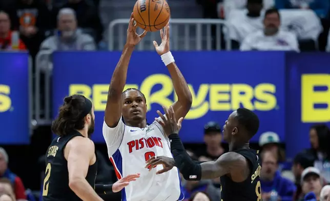 Detroit Pistons guard Ausar Thompson (9) passes the ball against Cleveland Cavaliers guard Max Strus (2) and guard Dennis Schroder (8) during the first half in Game 1 of a second-round NBA playoffs basketball series Tuesday, May 5, 2026, in Detroit. (AP Photo/Duane Burleson)