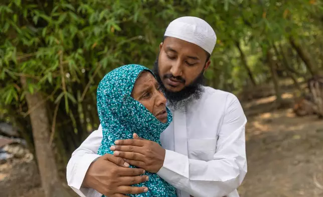 Maruf Hasan, brother of Mohammad Abdullah Al Mamun comforts his mother, Shahida Khatun, as she weeps at their home in Rasulpur village in Mymensingh district, Bangladesh, Friday, April 17, 2026. (AP Photo/Rajib Dhar)