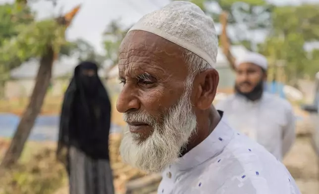 Sahidul Islam, center, the father of Mohammad Abdullah Al Mamun, stands with his relatives in Rasulpur village, Mymensingh district, Bangladesh, Friday, April 17, 2026.(AP Photo/Rajib Dhar)