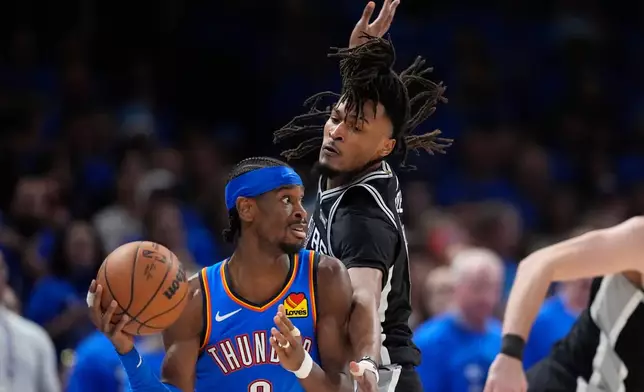 Oklahoma City Thunder guard Shai Gilgeous-Alexander (2) looks to pass the ball as San Antonio Spurs guard Stephon Castle defends during the second half of Game 7 of the Western Conference finals of the NBA basketball playoffs series Saturday, May 30, 2026, in Oklahoma City. (AP Photo/Tony Gutierrez)
