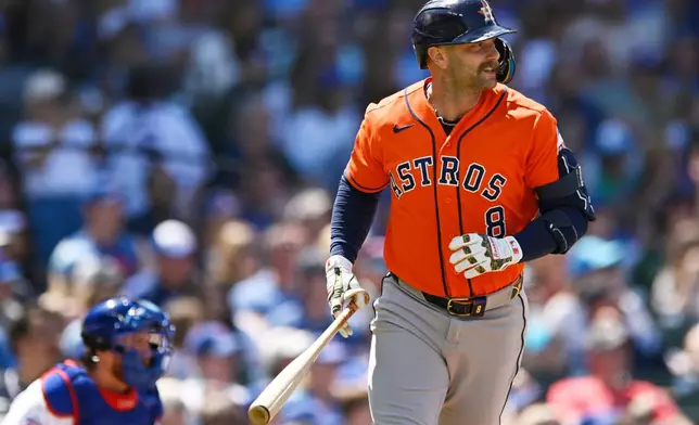 Houston Astros' Christian Walker (8) watches his three-run home run during the fifth inning of a baseball game against the Chicago Cubs in Chicago, Sunday, May 24, 2026. (AP Photo/Paul Beaty)