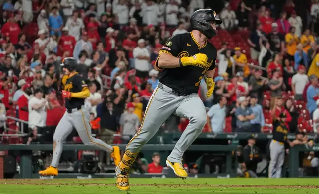 Pittsburgh Pirates' Spencer Horwitz, right, heads to first on an RBI single as teammate Konnor Griffin, left, scores during the ninth inning of a baseball game against St. Louis Cardinals Tuesday, May 19, 2026, in St. Louis. (AP Photo/Jeff Roberson)