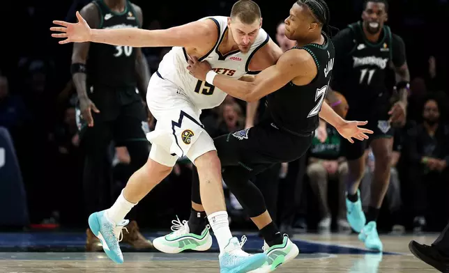 Denver Nuggets center Nikola Jokic, left, and Minnesota Timberwolves guard Jaylen Clark (22) get into an altercation during the second half of Game 6 of a first-round NBA basketball playoffs series, Thursday, April 30, 2026, in Minneapolis. (AP Photo/Matt Krohn)