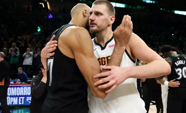 Denver Nuggets center Nikola Jokic, right, and Minnesota Timberwolves center Rudy Gobert hug after Game 6 of a first-round NBA basketball playoffs series, Thursday, April 30, 2026, in Minneapolis. (AP Photo/Matt Krohn)