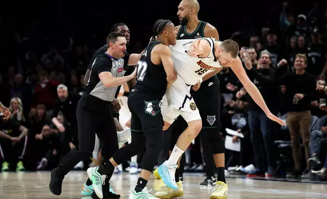 Denver Nuggets center Nikola Jokic and Minnesota Timberwolves guard Jaylen Clark get into an altercation during the second half of Game 6 of a first-round NBA basketball playoffs series, Thursday, April 30, 2026, in Minneapolis. (AP Photo/Matt Krohn)