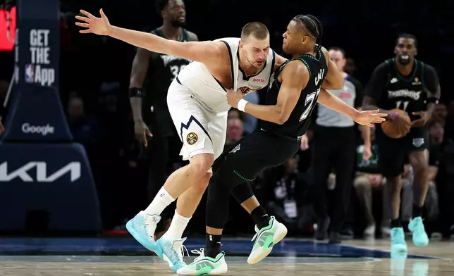 Denver Nuggets center Nikola Jokic, left, and Minnesota Timberwolves guard Jaylen Clark (22) get into an altercation during the second half of Game 6 of a first-round NBA basketball playoffs series, Thursday, April 30, 2026, in Minneapolis. (AP Photo/Matt Krohn)