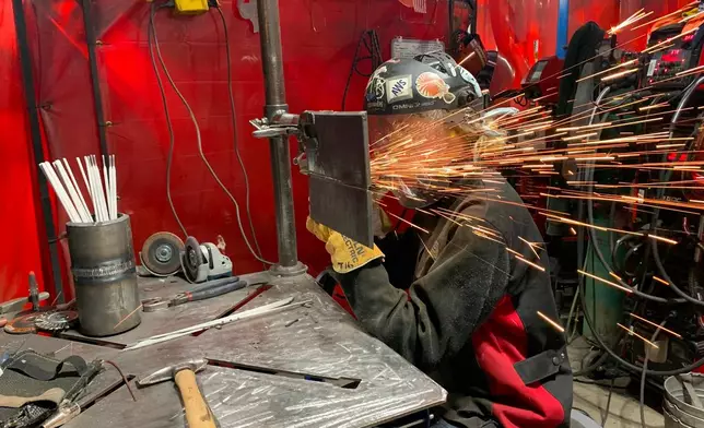 Student Mikala Sposito welds at Washtenaw Community College on Friday, May 1, 2026, in Ann Arbor., Mich. (AP Photo/Mike Householder)