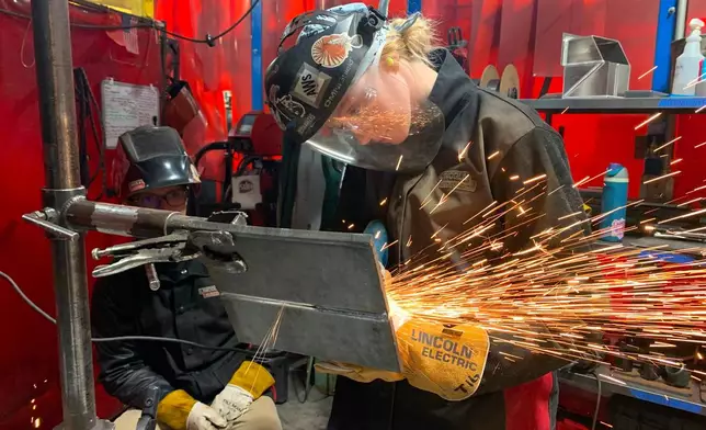 Student Mikala Sposito welds at Washtenaw Community College on Friday, May 1, 2026, in Ann Arbor., Mich. (AP Photo/Mike Householder)