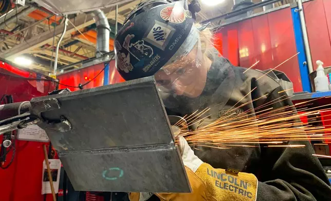 Student Mikala Sposito welds at Washtenaw Community College on Friday, May 1, 2026, in Ann Arbor., Mich. (AP Photo/Mike Householder)
