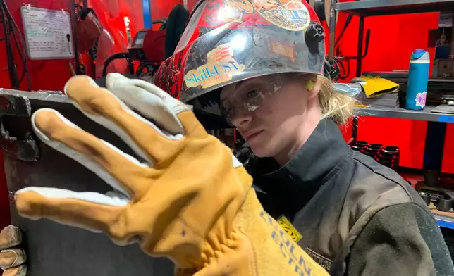 Student Mikala Sposito welds at Washtenaw Community College on Friday, May 1, 2026, in Ann Arbor., Mich. (AP Photo/Mike Householder)