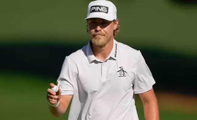 Kristoffer Reitan, of Norway, waves after a birdie on the 15th hole during the final round of the Truist Championship golf tournament at the Quail Hollow Club, Sunday, May 10, 2026, in Charlotte, N.C. (AP Photo/Chris Carlson)