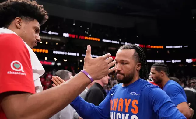 Atlanta Hawks forward Jalen Johnson (1) congratulates New York Knicks guard Jalen Brunson (11) after Game 6 in a first-round NBA basketball playoffs series Thursday, April 30, 2026, in Atlanta. (AP Photo/Brynn Anderson)