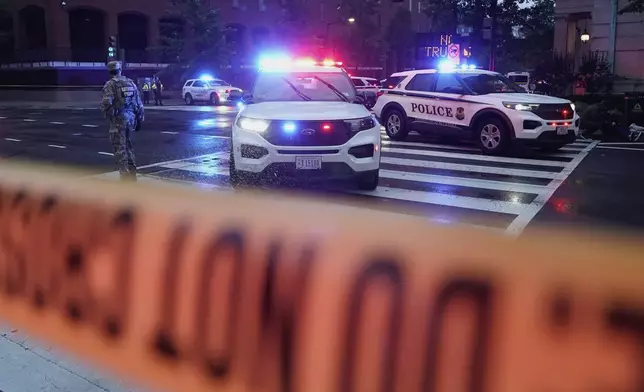 U.S. Secret Service Police are seen on a crime scene after responding to reports of shots fired near the White House, Saturday, May 23, 2026, in Washington. (AP Photo/Jose Luis Magana)
