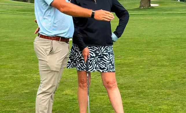 Braden Shattuck, a club professional who qualified to play in this weekend's PGA Championship at Aronimink Golf Club, instructs a golfer during a women's clinic at Rolling Green Golf Club, Wednesday, May 13, 2026, in Springfield, Pa. (AP Photo/Dan Gelston)