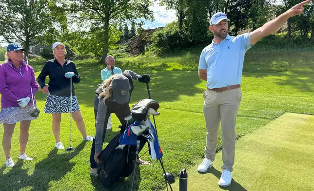Braden Shattuck, a club professional who qualified to play in this weekend's PGA Championship at Aronimink Golf Club, instructs a golfers during a women's clinic at Rolling Green Golf Club, Wednesday, May 13, 2026, in Springfield, Pa. (AP Photo/Dan Gelston)