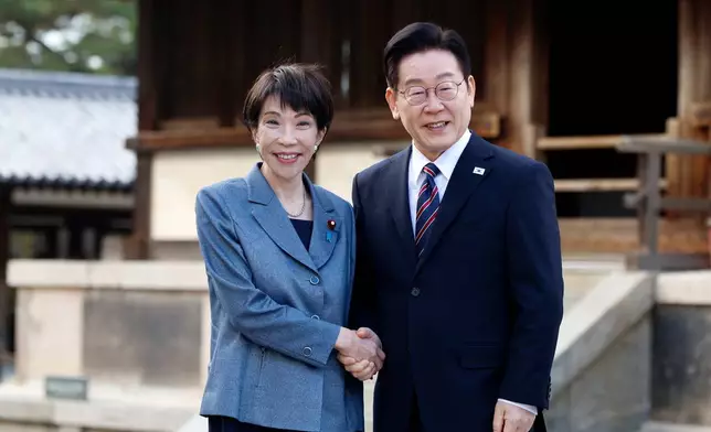 File - Japanese Prime Minister Sanae Takaichi, left, and South Korean President Lee Jae Myung pose as they visit the Western Precinct or Saiin Garan, at the Horyuji Temple in Ikaruga, Nara prefecture, western Japan, Jan. 14, 2026. (Franck Robichon/Pool Photo via AP, File)