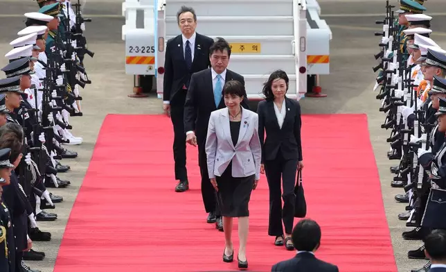 Japan's Prime Minister Sanae Takaichi, center, inspects an honor guard upon arrival at the Daegu International Airport in Daegu, South Korea, Tuesday, May 19, 2026. (Yoon Kwan-shick/Yonhap via AP)