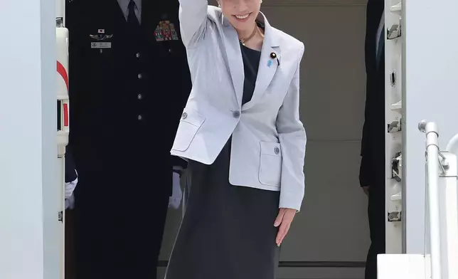 Japan's Prime Minister Sanae Takaichi waves upon arrival at the Daegu International Airport in Daegu, South Korea, Tuesday, May 19, 2026. (Yoon Kwan-shick/Yonhap via AP)