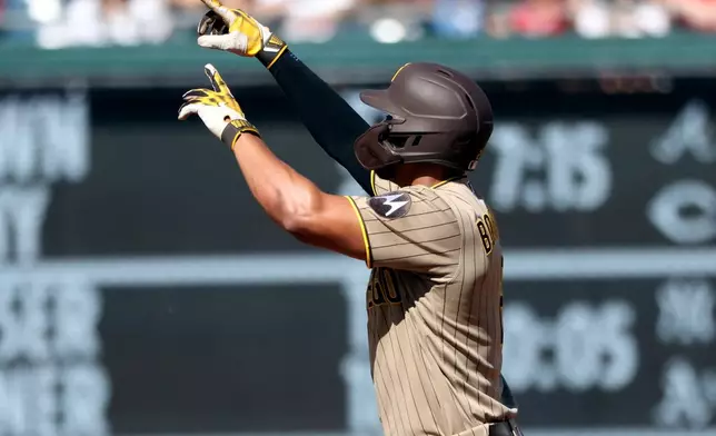 San Diego Padres' Xander Bogaerts celebrates after hitting a home run during the second inning of a baseball game against the Washington Nationals, Saturday, May 30, 2026, in Washington. (AP Photo/Daniel Kucin Jr.)