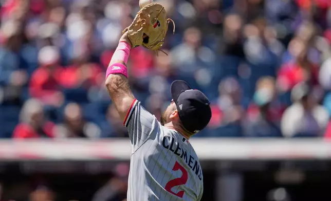 Minnesota Twins first baseman Kody Clemens (2) catches a pop up hit for an out by Cleveland Guardians' Patrick Bailey in the second inning of a baseball game in Cleveland, Sunday, May 10, 2026. (AP Photo/Sue Ogrocki)