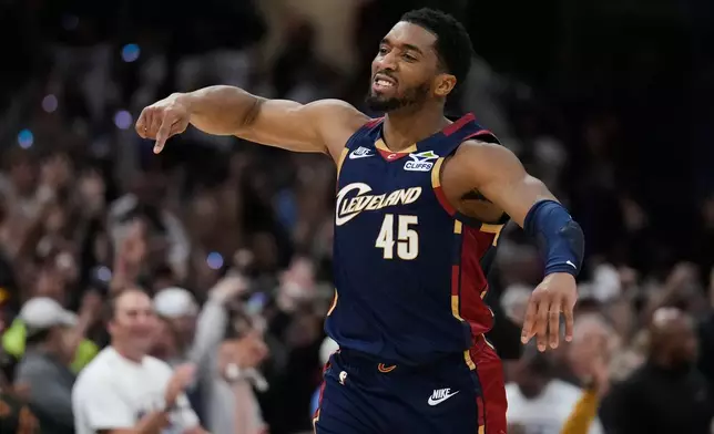 Cleveland Cavaliers' Donovan Mitchell (45) gestures after hitting a three-point basket inthe second half of Game 4 of a second-round NBA basketball playoff series against the Detroit Pistons Monday, May 11, 2026, in Cleveland. (AP Photo/Sue Ogrocki)