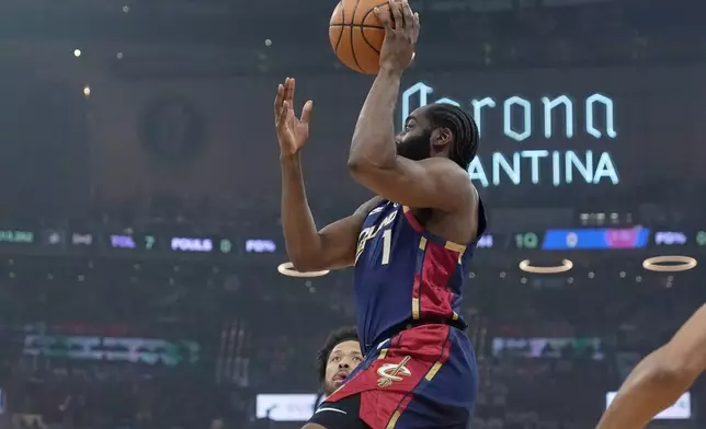 Cleveland Cavaliers' James Harden, right, shoots in front of Detroit Pistons' Cade Cunningham, rear, in the first half of Game 4 of a second-round NBA basketball playoff series Monday, May 11, 2026, in Cleveland. (AP Photo/Sue Ogrocki)