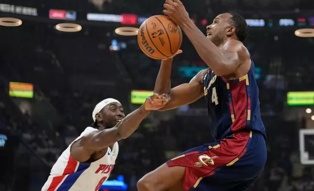 Detroit Pistons' Caris LeVert, left, knocks the ball away from Cleveland Cavaliers' Evan Mobley (4) in the first half of Game 4 of a second-round NBA basketball playoff series Monday, May 11, 2026, in Cleveland. (AP Photo/Sue Ogrocki)