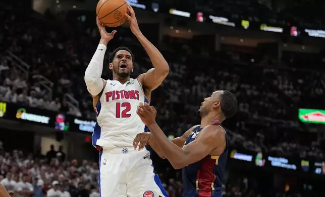 Detroit Pistons' Tobias Harris (12) shoots over Cleveland Cavaliers' Evan Mobley, right, in the second half of Game 4 of a second-round NBA basketball playoff series Monday, May 11, 2026, in Cleveland. (AP Photo/Sue Ogrocki)