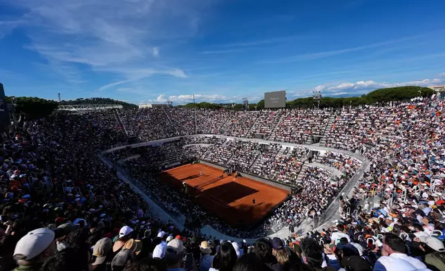 Jannik Sinner, of Italy, right, and Casper Ruud, of Norway, on the court at the start of the final match at the Italian Open tennis tournament, in Rome, Sunday, May 17, 2026. (AP Photo/Alessandra Tarantino)