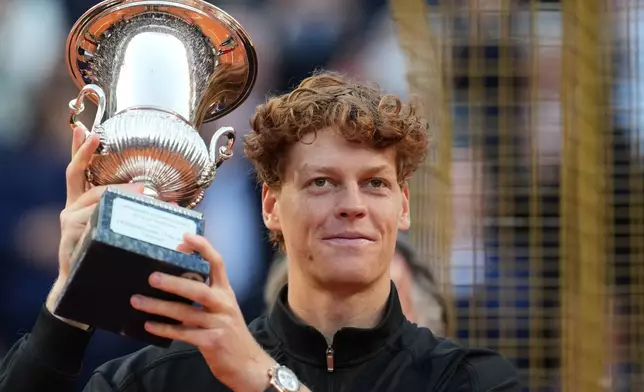 Jannik Sinner, of Italy, holds his trophy after defeating Casper Ruud, of Norway, 6/4, 6/4 in the final match to win the Italian Open tennis tournament, in Rome, Sunday, May 17, 2026. (AP Photo/Andrew Medichini)