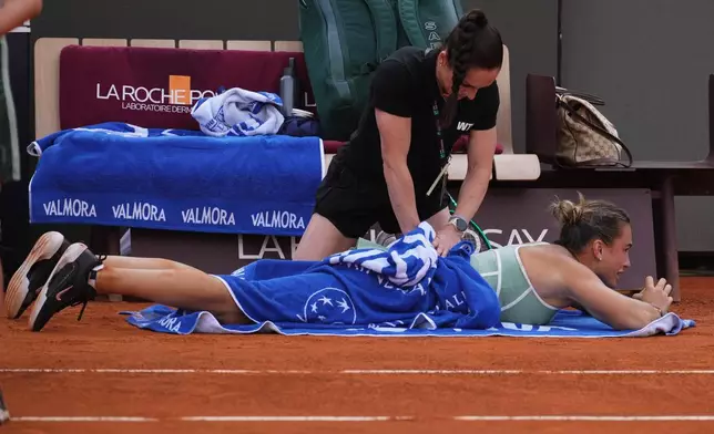 Belarus' Aryna Sabalenka gets medical assistance during the match against Romania's Sorana Cirstea at the Italian Open tennis tournament in Rome, Saturday, May 9, 2026. (AP Photo/Alessandra Tarantino)