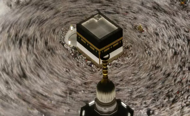 This photograph made with a slow shutter speed shows Muslim pilgrims circumambulating the Kaaba, Islam's holiest site at the Grand Mosque during the annual Hajj pilgrimage in Mecca, Saudi Arabia, Sunday, May 24, 2026. (AP Photo/Altaf Qadri)