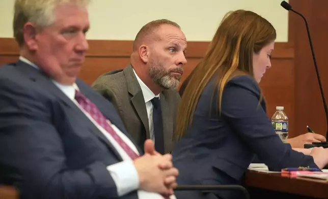 FILE - Jason Meade, center, sits with his attorneys Mark Collins, left, and Kaitlyn Stephens, right, during opening statements in the retrial of the former Ohio sheriff's deputy charged with murder and reckless homicide in the 2020 killing of Casey Goodson Jr., inside Franklin County Common Pleas Court in Columbus, Ohio, April 23, 2026. (Doral Chenoweth/Pool photo via AP, File)