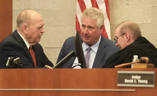 Special prosecutor Tim Merkle, left, talks with defense attorney Mark Collins and Judge David Young speak during closing arguments in former sheriff's deputy Jason Meade's retrial inside Franklin County Court of Common Pleas on Wednesday, May 6, 2026, in Columbus, Ohio. (Doral Chenoweth/The Columbus Dispatch via AP, Pool)