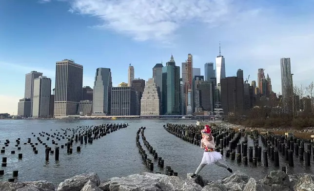 FILE - With One World Trade Center seen in the background, a little girl leaps across boulders forming a breakwater along the Brooklyn Bridge Park on Dec. 27, 2018, in the Brooklyn borough, of New York. (AP Photo/Wong Maye-E, File)