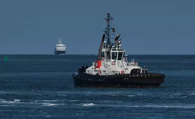 The MV Hondius cruise ship, left, arrives just outside the Port of Rotterdam, Netherlands, Monday, May 18, 2026. (AP Photo/Patrick Post)