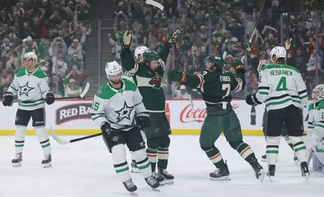 Minnesota Wild defenseman Quinn Hughes (43) celebrates after scoring against Dallas Stars goaltender Jake Oettinger during the first period of Game 6 in the first round of the NHL hockey Stanley Cup playoff series Thursday, April 30, 2026, in St. Paul, Minn. (AP Photo/Bailey Hillesheim)