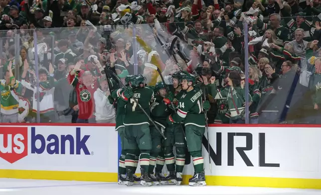 Minnesota Wild left wing Matt Boldy, second from the right, celebrates with teammates after scoring during the third period of Game 6 in the first round of the NHL hockey Stanley Cup playoff series against the Dallas Stars, Thursday, April 30, 2026, in St. Paul, Minn. (AP Photo/Bailey Hillesheim)