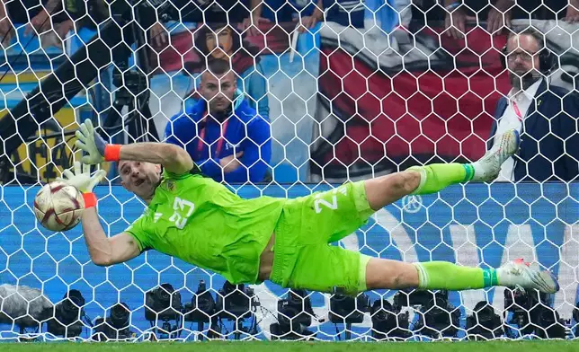 FILE - Argentina's goalkeeper Emiliano Martinez blocks a shot by France's Kingsley Coman during a penalty shootout in the World Cup final soccer match between Argentina and France at the Lusail Stadium in Lusail, Qatar, Sunday, Dec. 18, 2022. (AP Photo/Natacha Pisarenko, File)