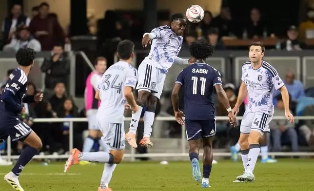 San Jose Earthquakes midfielder Jamar Ricketts, middle, jumps for the ball against the Vancouver Whitecaps during the second half of an MLS soccer match Saturday, May 9, 2026, in San Jose, Calif. (AP Photo/Jeff Chiu)