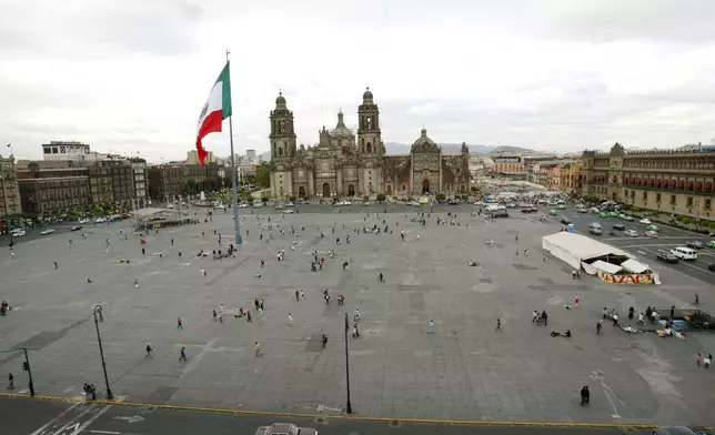 FILE - A bird's eye view of the Zocalo and a sinking Metropolitan Cathedral in Mexico City, June 21, 2005. (AP Photo/Marco Ugarte, File)