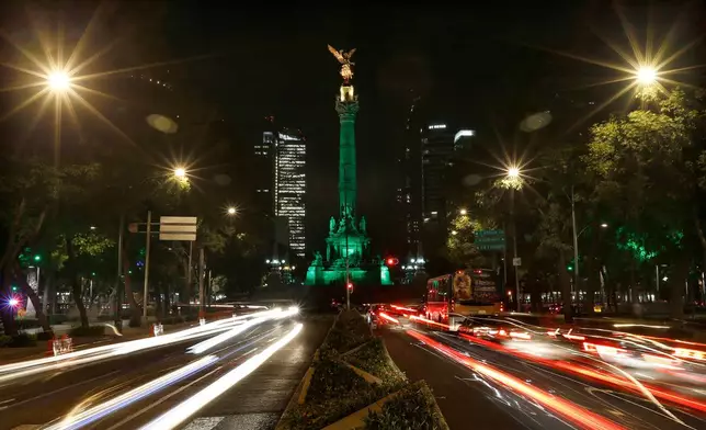 FILE - Cars drive past the Angel of Independence monument in Mexico City, June 1, 2017. (AP Photo/Marco Ugarte, File)