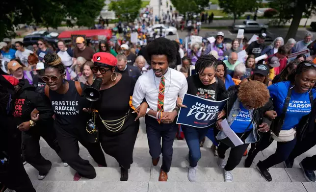 Rep. Justin J. Pearson, D-Memphis, center, marches with protesters before a special session of the state legislature to redraw U.S. Congressional voting maps, in Nashville, Tenn., Tuesday, May 5, 2026. (AP Photo/George Walker IV)