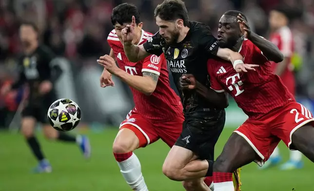 Bayern's Dayot Upamecano, right, challenges PSG's Khvicha Kvaratskhelia during the Champions League semifinal second leg soccer match between Bayern Munich and Paris Saint Germain in Munich, Germany, Wednesday, May 6, 2026. (AP Photo/Matthias Schrader)