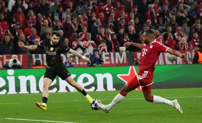 PSG's Khvicha Kvaratskhelia, left, kicks the ball as Bayern's Dayot Upamecano tries to stop him during the Champions League semifinal second leg soccer match between Bayern Munich and Paris Saint Germain in Munich, Germany, Wednesday, May 6, 2026. (AP Photo/Martin Meissner)