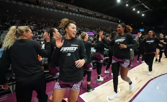 Toronto Tempo's Kiki Rice, front right, high-fives teammates prior to a WNBA basketball game against the Washington Mystics in Toronto, Friday, May 8, 2026. (Nathan Denette/The Canadian Press via AP)