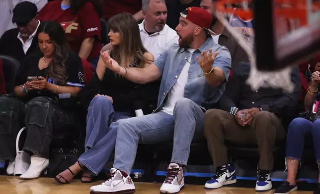 Taylor Swift and Travis Kelce watch the first half of Game 3 in the Eastern Conference finals NBA basketball playoffs series between the New York Knicks and the Cleveland Cavaliers in Cleveland, Saturday, May 23, 2026. (AP Photo/Tim Phillis)