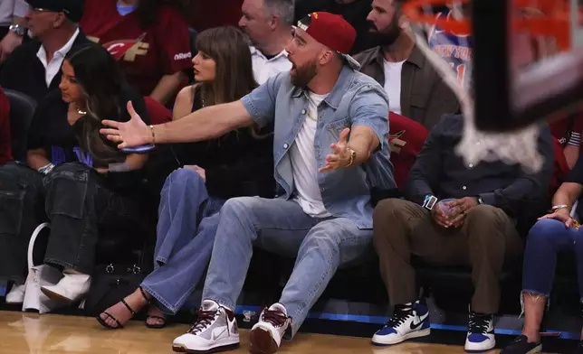 Taylor Swift and Travis Kelce watch the first half of Game 3 in the Eastern Conference finals NBA basketball playoffs series between the New York Knicks and the Cleveland Cavaliers in Cleveland, Saturday, May 23, 2026. (AP Photo/Tim Phillis)