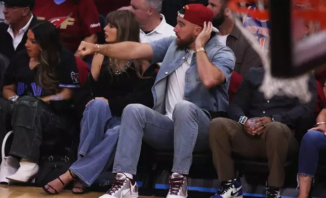 Taylor Swift and Travis Kelce watch the first half of Game 3 in the Eastern Conference finals NBA basketball playoffs series between the New York Knicks and the Cleveland Cavaliers in Cleveland, Saturday, May 23, 2026. (AP Photo/Tim Phillis)